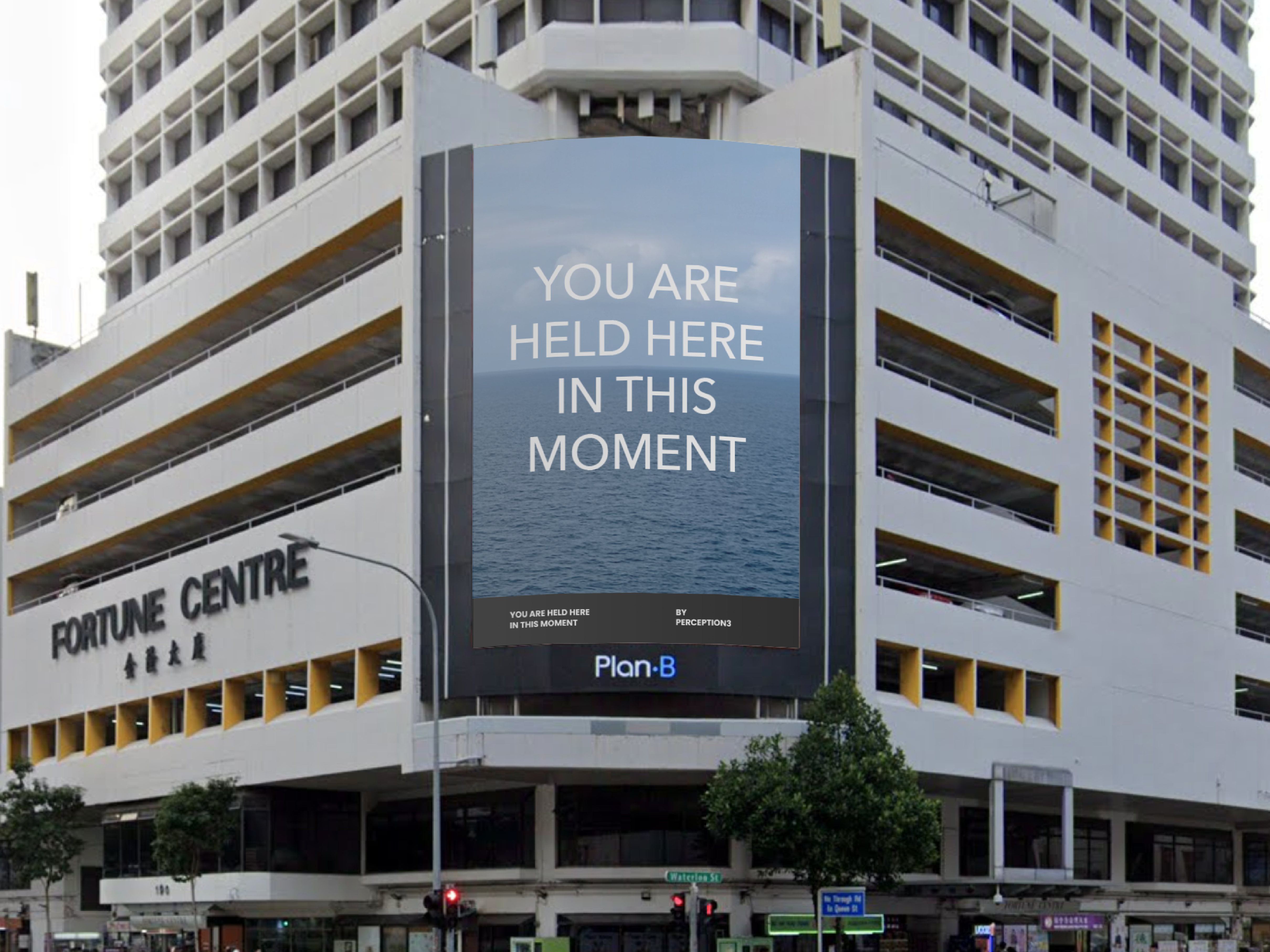 The text 'You are held here in this moment' on display at a large screen on the side of the Fortune Centre building